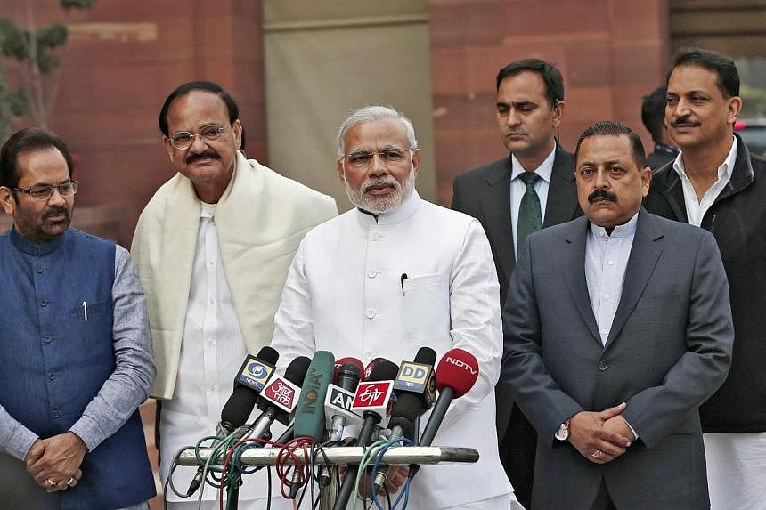 India's Prime Minister Narendra Modi (third left) speaks on the opening day of the winter session of the Indian Parliament,&nbsp;flanked by members of his Cabinet,&nbsp;in New Delhi on Nov 24, 2014. India's Parliament was thrown into disarray on Dec 