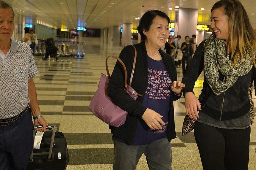 Colleen Turzynski is reunited with her Singapore family members, aunt, Mdm Lee Say Moi (centre) and her uncle Mr Lee Tak Nyen at Changi Airport.&nbsp;Colleen arrived from Washinton DC in the wee hours of Tuesday morning.&nbsp;-- PHOTO: CAROLINE CHIA