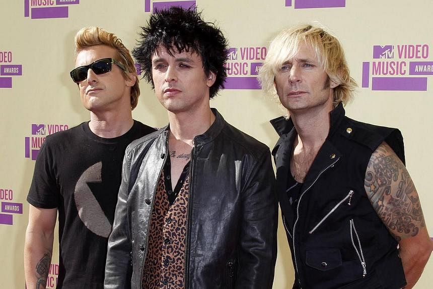 Green Day members (from left) Mike Dirnt, Billie Joe Armstrong and Tre Cool arrive&nbsp;for the 2012 MTV Video Music Awards in Los Angeles, in this September 6, 2012 file photo. The latter-generation punk rock group on Tuesday&nbsp;won spots in the R