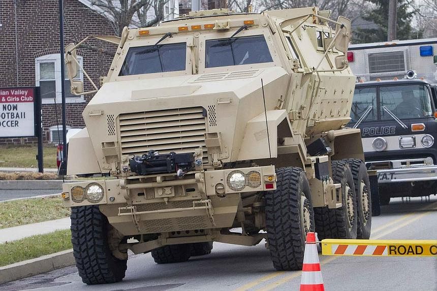 A police armoured vehicle is seen near a home in a suburb of Philadelphia where a suspect in five killings was believed to be barricaded in Souderton, Pennsylvania, on Dec 15, 2014. -- PHOTO: REUTERS