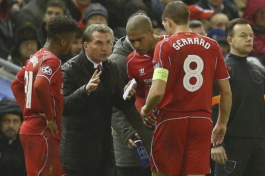 Liverpool's manager Brendan Rodgers (holding notepad) speaks to Steven Gerrard (no. 8) during their Champions League Group B football match against FC Basel at Anfield in Liverpool, northern England on Dec 9, 2014. -- PHOTO: REUTERS