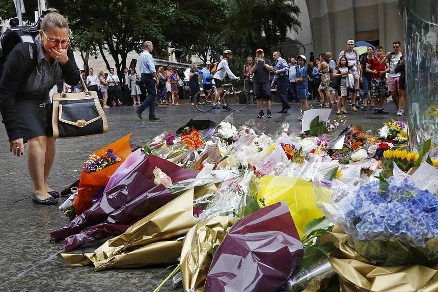 A floral tribute for those who died in the Sydney cafe siege, near the site of the incident, in Martin Place on Dec 16, 2014. -- PHOTO: REUTERS