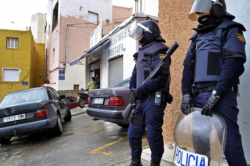 A file picture taken on March 14, 2014 shows policemen taking part to an operation against a militant cell in the Spanish city of Melilla. Spain is ramping up its fight against "home-grown" Islamic extremism, raiding suspected cells and hunting radic