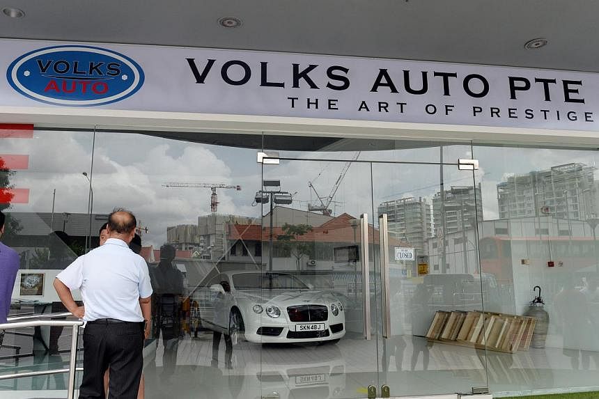 More than 20 people gathered outside Volks Auto at Macpherson on Dec 15, 2014. -- ST PHOTO: AZIZ HUSSIN