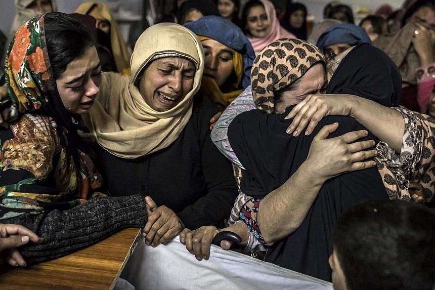 Women mourn their relative Mohammed Ali Khan, 15, a student who was killed during the attack. -- PHOTO: REUTERS