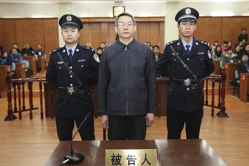 Liu Tienan (centre), the former deputy head of China's top planning agency, stands during his verdict at a court in Langfang, Hebei province, in this Dec 10, 2014 handout photo supplied by the Langfang Intermediate People's Court. -- PHOTO: REUTERS