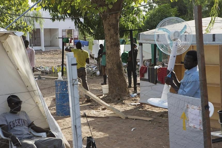 A man brings a fan into an Ebola treatment center in Bamako, Mali, on Nov 13, 2014.&nbsp;Border closures, quarantines and crop losses in West African nations battling the Ebola virus could lead to as many as one million people going hungry, UN food a