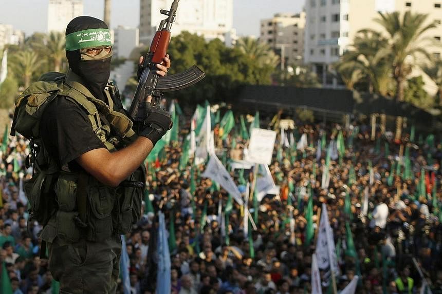 A Hamas militant celebrates with people what they said was a victory over Israel, in Gaza City in this Aug 27, 2014 file photo.&nbsp;The EU said on Wednesday, Dec 14, 2014, that it still considers Hamas to be a "terrorist" group even though a Europea