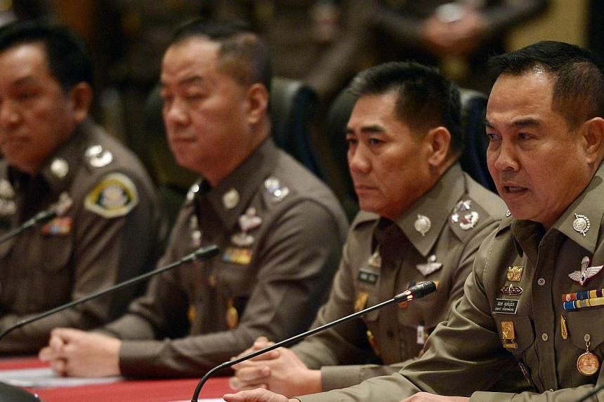 Thai national police chief Somyot Poompanmoung (right) addresses reporters during a press conference at the Royal Thai Police headquarters in Bangkok on Nov 25, 2014.&nbsp;The Thai junta on Wednesday, Dec 17, 2014, said it will "hunt" fugitives wante