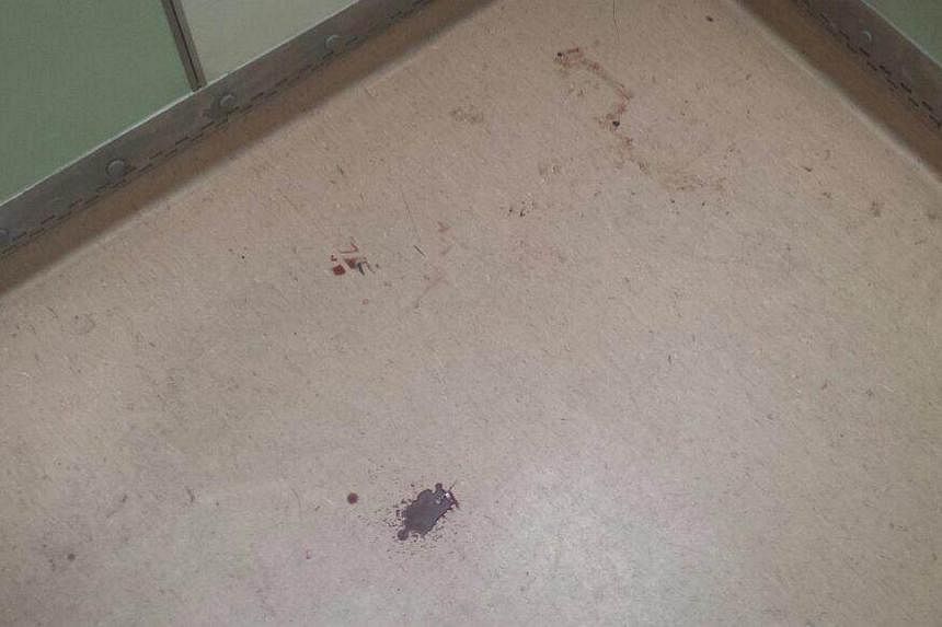 The blood trail, in Blk 505 Tampines Central 1, left by the fleeing suspect. -- ST PHOTO: AW CHENG WEI&nbsp;