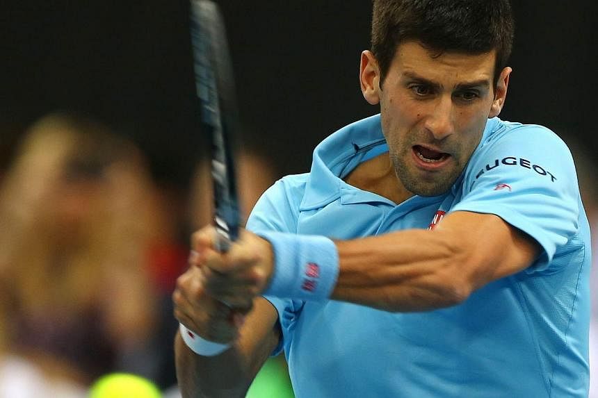 Serbian player Novak Djokovic of the UAE Royals returns the ball to France's Gael Monfils of the Indian Aces during their International Premier Tennis League match at the Hamdan Sports Complex in Dubai on Dec 13, 2014. -- PHOTO: AFP