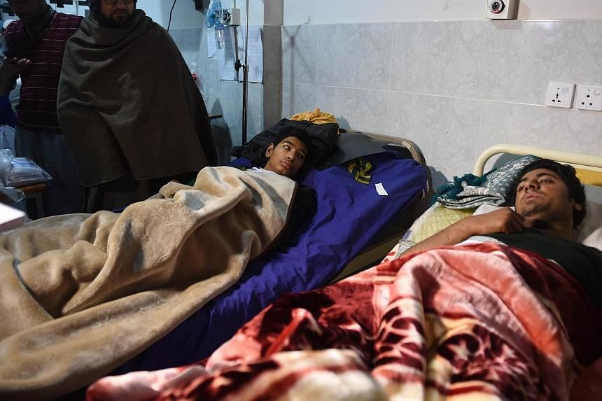 Wounded Pakistanis rest at a hospital after Taleban gunmen attacked a school in Peshawar on Dec 17, 2014.