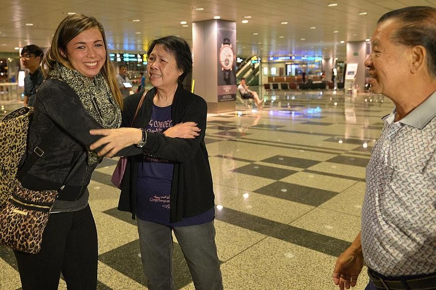 Ms Colleen Turzynski meeting her Singapore relatives - her aunt Lee Say Moi and uncle Lee Tak Nyen - in person for the first time upon her arrival at Changi Airport from the United States early yesterday morning. A visit to her late mother's niche at