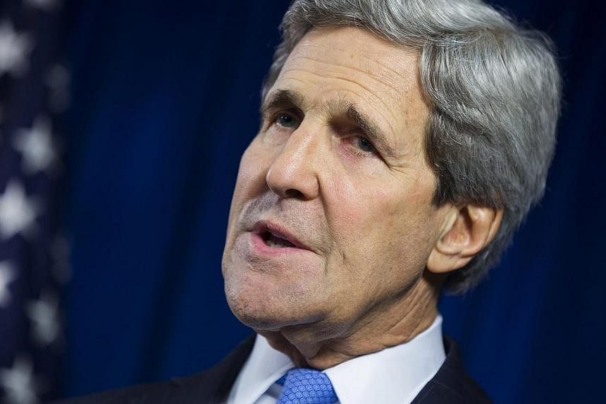 US Secretary of State John Kerry delivers remarks during a news conference at the US Embassy in London Dec 16, 2014. US and European sanctions against Russia could be lifted within days if President Vladimir Putin made the right choices in Ukraine, t