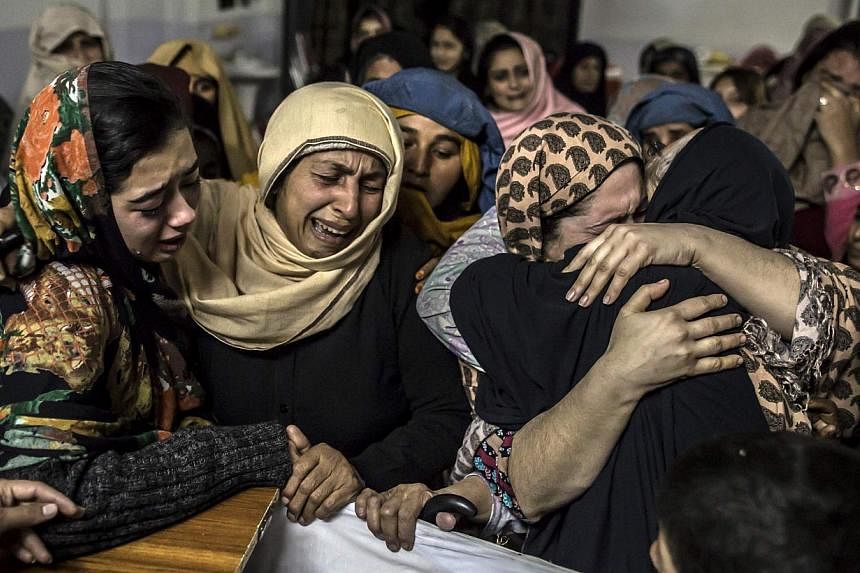 Pakistani women mourn their relative, a student who was killed during the attack by Taleban gunmen on the Army Public School, at his house in Peshawar on Dec 16, 2014. -- PHOTO: REUTERS&nbsp;