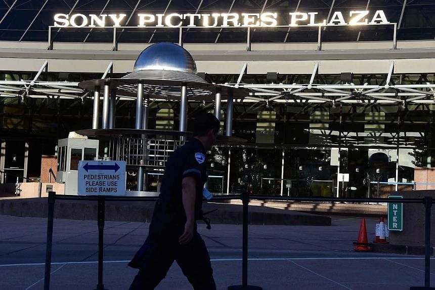 A security guard walks past the entrance to Sony Pictures Plaza in Los Angeles, California earlier this month. -- PHOTO: AFP