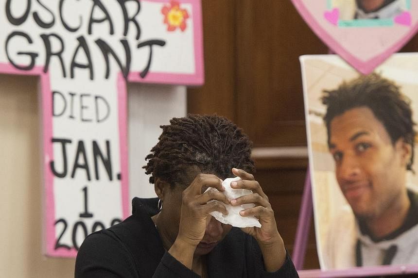 Tressa Sherrod cries after telling the story of her son, 22-year-old John Crawford III who was shot and killed by police in an Ohio Walmart, during a press conference with other mothers who have lost children during police action as they call for pol
