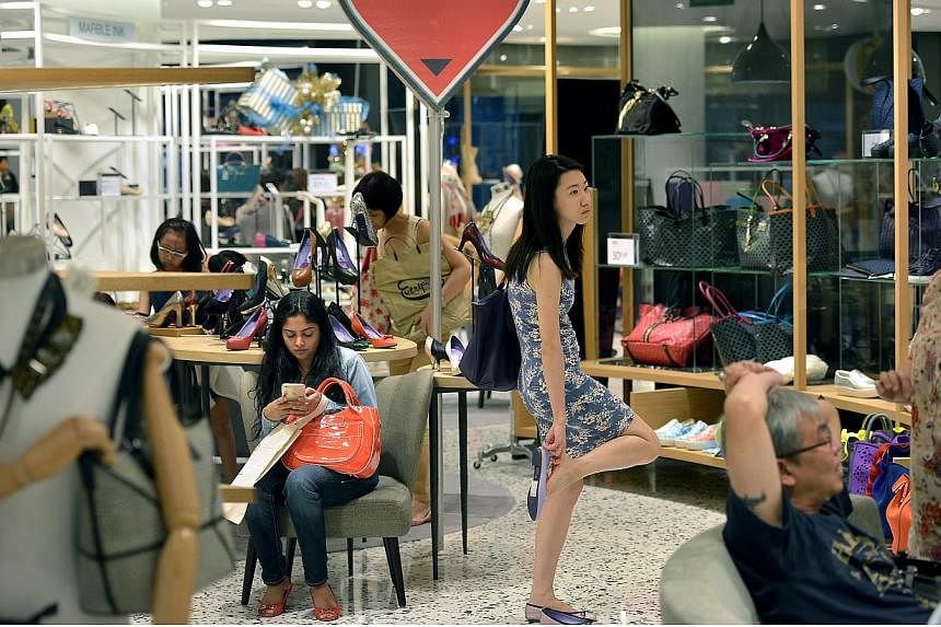 Shoppers at Robinsons at The Heeren in Orchard Road on Nov 28, 2014. Shoppers have tightened their budgets when it comes to buying gifts for the festive season this year, according to a recent survey commissioned by United Overseas Bank Group. -- PHO