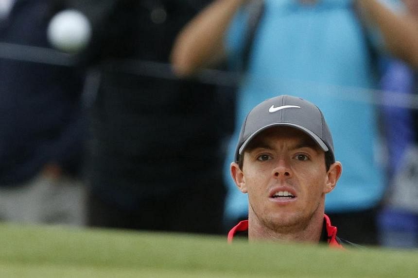 Northern Ireland's Rory McIlroy plays out of a bunker during the first round of the Australian Open golf tournament in Sydney, Nov 27, 2014. McIlroy said on Tuesday that golf should be made quicker at grassroots level in order to attract more young p