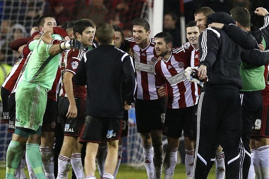 Sheffield United players celebrate after beating Southampton at Bramall Lane in the League Cup. -- PHOTO: REUTERS&nbsp;