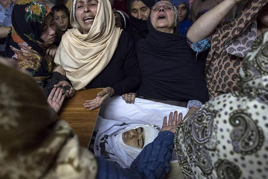 Women mourn their relative Mohammed Ali Khan, 15, a student who was killed during an attack by Taliban gunmen on the Army Public School, at his house in Peshawar December 16, 2014. -- PHOTO: REUTERS