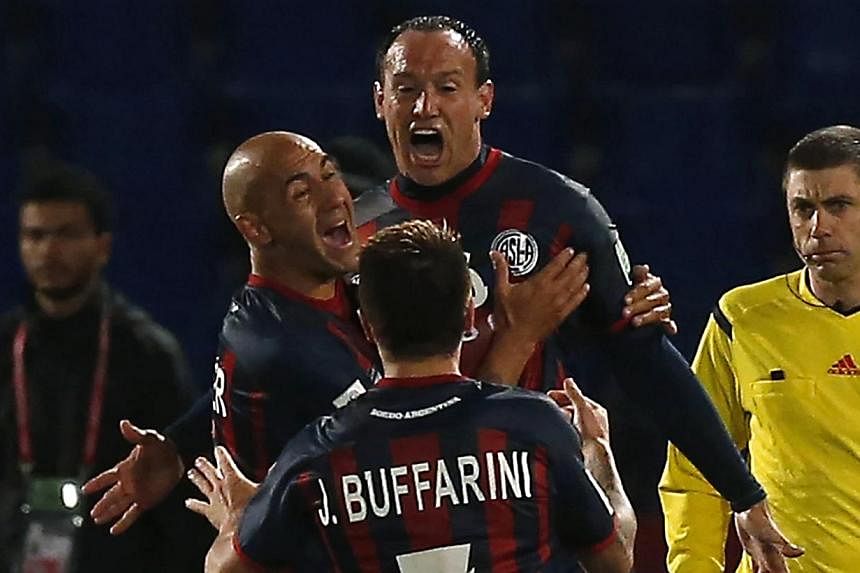 Mauro Matos (centre) of San Lorenzo celebrates with his teammates after scoring a goal against Auckland City during their Club World Cup semi-final soccer match at Marrakech stadium on Dec 17, 2014. -- PHOTO: REUTERS