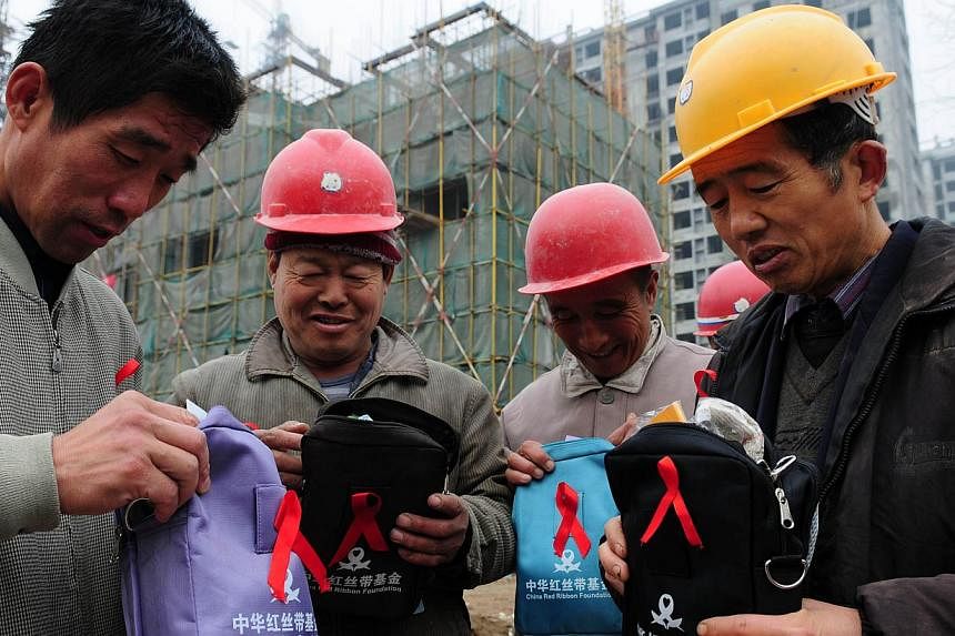 Migrant workers receiving health packages from volunteers in Liaocheng, Shandong province, on Nov 30, 2014. The World Health Organisation issued a call to action to China on Dec 1, 2014 over HIV/Aids as government figures said nearly half a million p