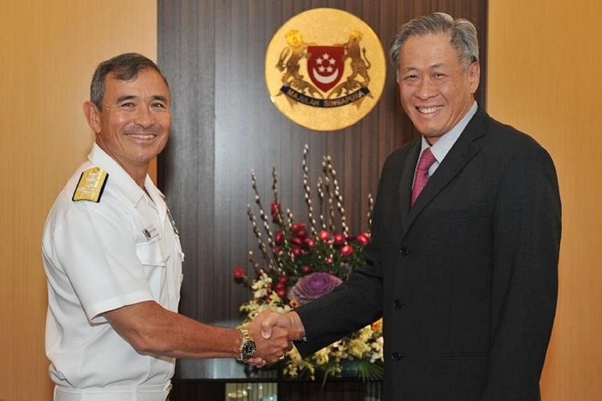 Commander of the US Pacific Fleet, Admiral Harry Harris (left) shaking hands with Defence Minister Ng Eng Hen on Jan 21, 2014. The United States and Singapore navies re-affirmed relations on Thursday, as the commander of the US Pacific Fleet called o