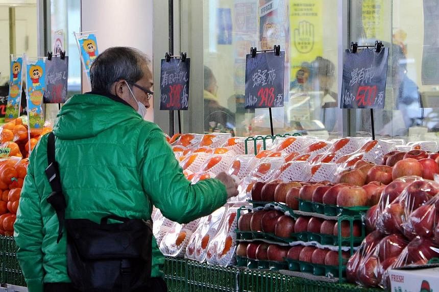 An elderly man a food supermarket in Tokyo on Dec 8, 2014. Japan will spend over 3 trillion yen (S$33 billion) in a stimulus package aimed at reviving regional economies hit by slumping household spending after a sales tax hike in April. -- PHOTO: AF