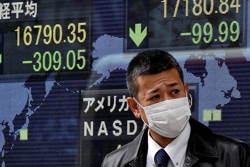Share prices on display in Tokyo on Dec 16, 2014. Asian shares looked to rally on opening on Thursday after US stocks enjoyed their strongest session this year. -- PHOTO: AFP