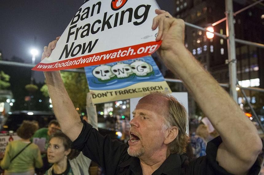 Protesters demonstrate against fracking, as New York State Governor Andrew Cuomo takes part in a book signing promoting his new book, All Things Possible, in New York Oct 15, 2014. Cuomo said Wednesday he would ban hydraulic fracking in New York Stat