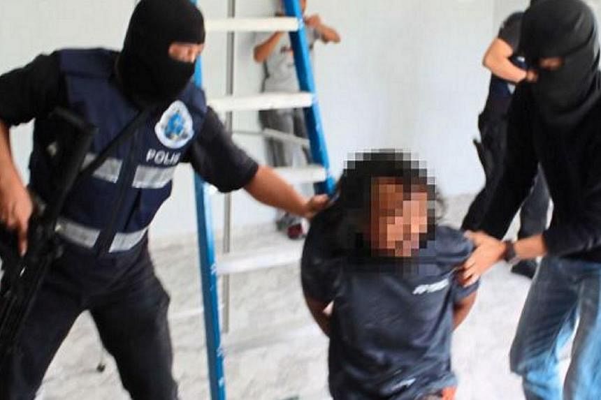 A suspect who is a civil servant was among the three arrested by the Malaysian police for suspected links with the Islamic State (ISIS) group. -- PHOTO: THE STAR/ASIA NEWS NETWORK