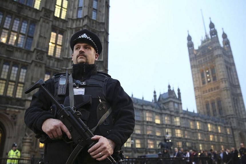 An armed police officer stands outside the Houses of Parliament, central London Nov 26 , 2014.&nbsp;Police looking into accusations that powerful figures at the heart of the British establishment were involved in child sex abuse in the 1970s and 1980