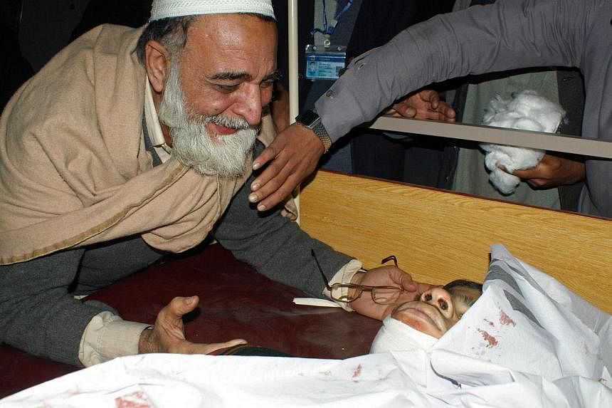 A Pakistani father mourns beside the body of his son at a hospital following an attack by Taleban gunmen on a school in Peshawar on Dec 16, 2014.&nbsp;Taleban gunmen who stormed a school in north-west Pakistan toyed with captive students by suggestin