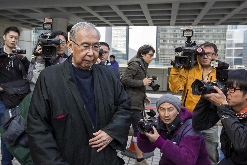 Hong Kong's former chief secretary Rafael Hui leaves during a lunch break at the High Court in Hong Kong on Dec 16, 2014. -- PHOTO: AFP