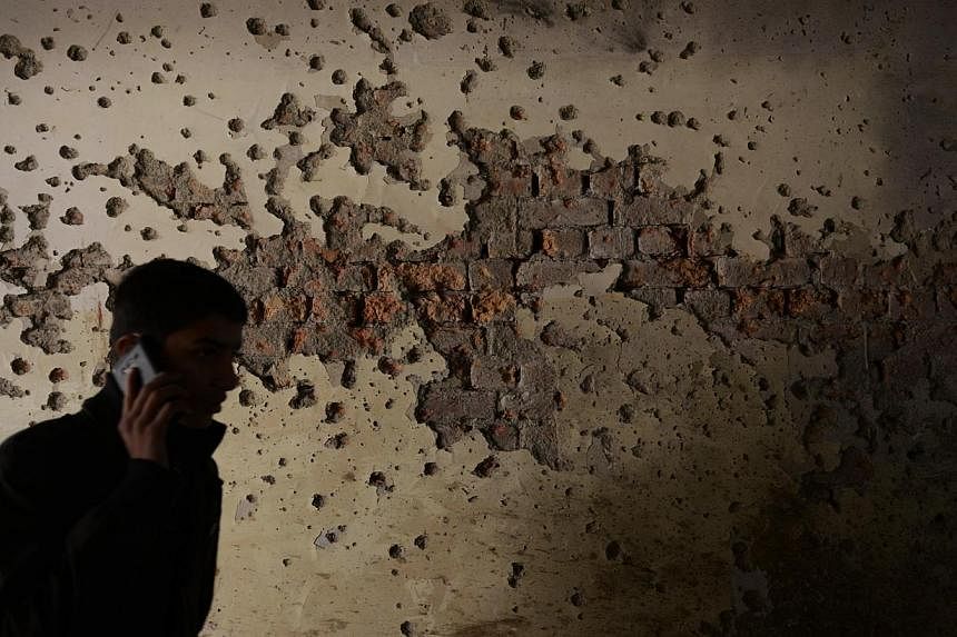 A student walks past a bullet-riddled wall inside the army-run school. Pakistan's military said on Friday that it had killed 32 militants in clashes in a troubled tribal region near the Afghan border, days after the Taleban massacre killed 148 people