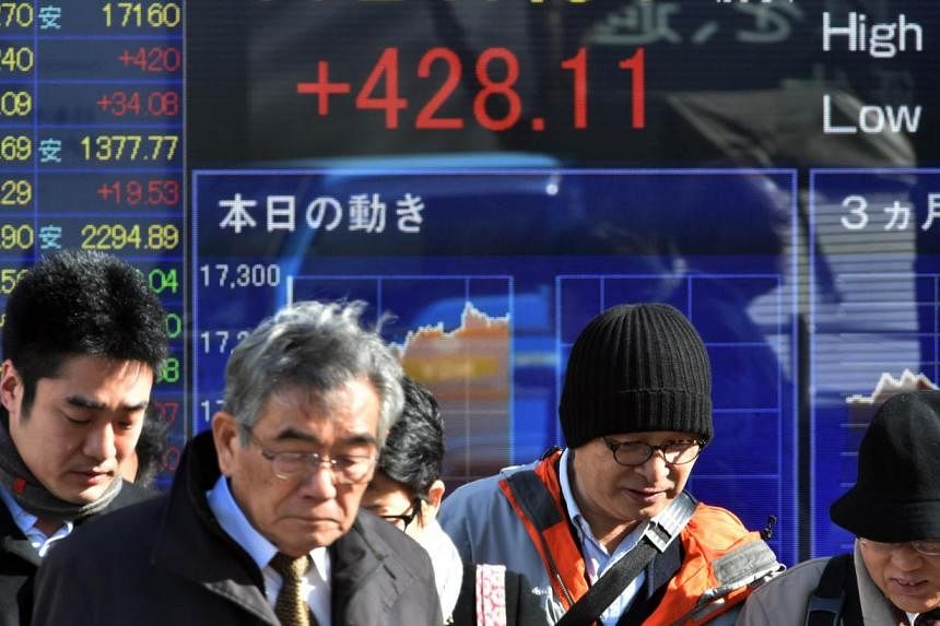 Asian shares enjoyed their best day in 15 months on Friday, after Wall Street boasted its biggest two-day advance since late 2011. -- PHOTO: AFP