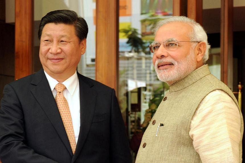 Mr Xi being greeted by India's Prime Minister Narendra Modi in Ahmedabad in September. Mr Xi's overseas travels have paid off as the survey shows he is rated better in countries he has visited.