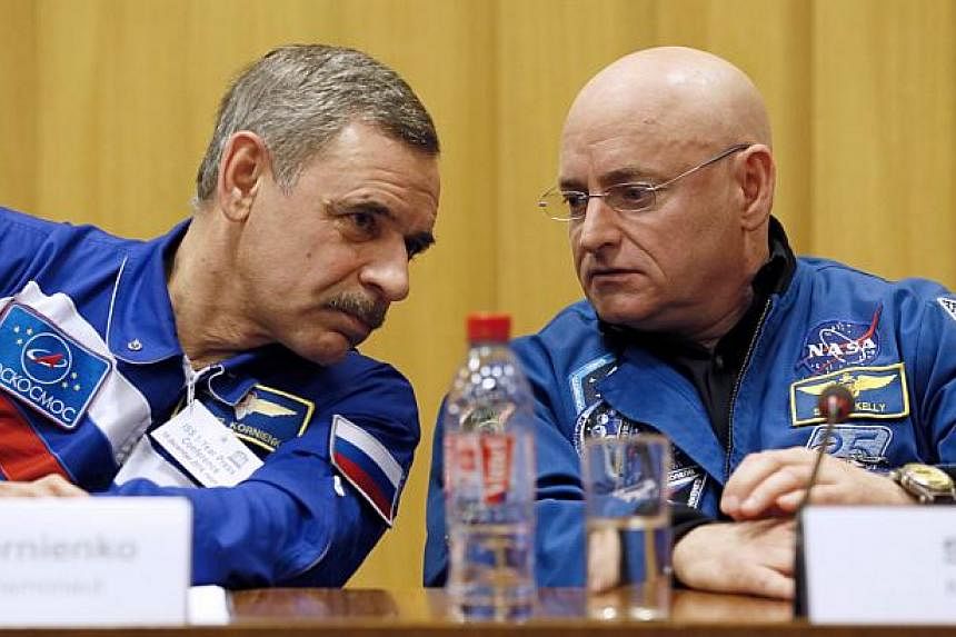 Nasa astronaut Scott Kelly (right) and Roscosmos cosmonaut Mikhail Kornienko of Russia give a press conference on Dec 18, 2014 in Paris. The pair,&nbsp;gearing up for the longest-ever flight on the International Space Station, &nbsp;said on Thursday 