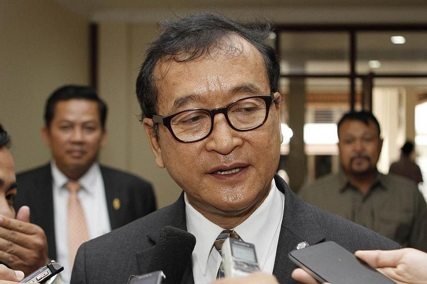 Head of the opposition Cambodia National Rescue Party (CNRP) Sam Rainsy addresses reporters at the National Assembly building in Phnom Penh on Dec 19, 2014. -- PHOTO: AFP