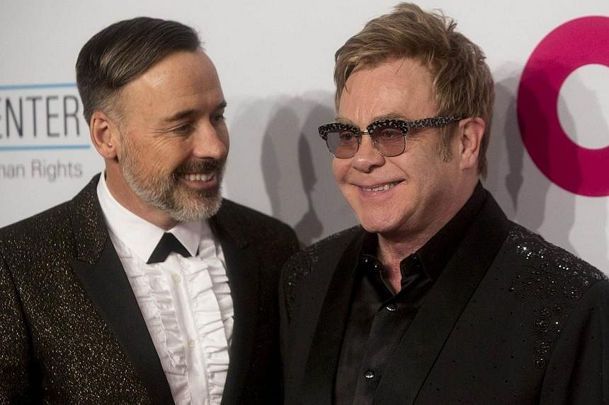 David Furnish (left) and Sir Elton John attend an Elton John Aids Foundation benefit in New York on Oct 28, 2014. Pop icon Elton John will wed his partner of more than 20 years this weekend in England, reports said. -- PHOTO:&nbsp;REUTERS