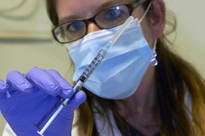 A nurse holds a syringe containing an experimental Ebola virus vaccine during a media visit at the Lausanne University Hospital (CHUV) in Lausanne in this Nov 4, 2014 file photo. -- PHOTO: REUTERS