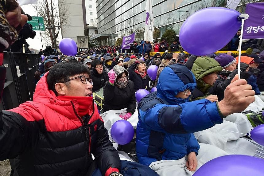 Members of South Korea's Unified Progressive Party (UPP) chanting slogans during a rally on a street near the the Constitutional Court in Seoul on Dec 19, 2014 after the court ruled the government's petition to disband the party. South Korea's nascen