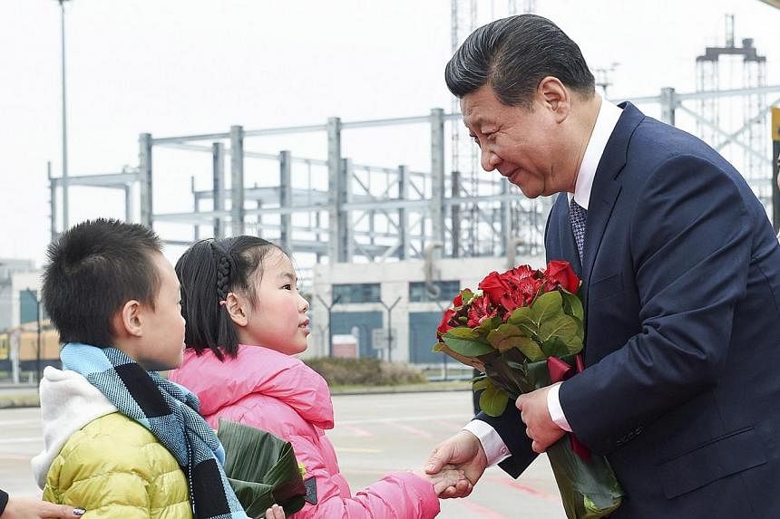 Chinese President Xi Jinping shaking hands with a child as he receives a bouquet upon arriving in Macau to celebrate the 15th anniversary of its handover to the mainland on Dec 19, 2014. Macau's gambling take, which makes up 80 per cent of its revenu