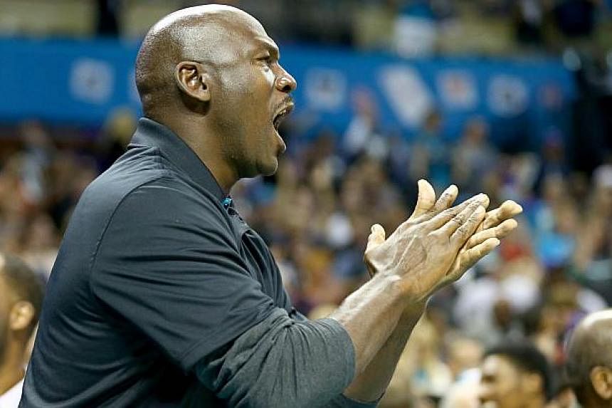 Michael Jordan, owner of the Charlotte Hornets, looks on during their game against the Milwaukee Bucks at Time Warner Cable Arena on Oct 29, 2014 in Charlotte, North Carolina.&nbsp;A pair of sneakers worn by Michael Jordan when he played basketball a
