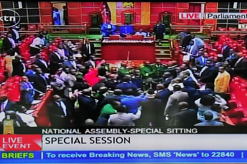 An image grab taken from a video by Kenya Television Network on Dec 18, 2014 shows scuffles breaking out in Kenya's parliament in Nairobi, delaying a vote on controversial legislation that would give the authorities sweeping powers to pursue terroris