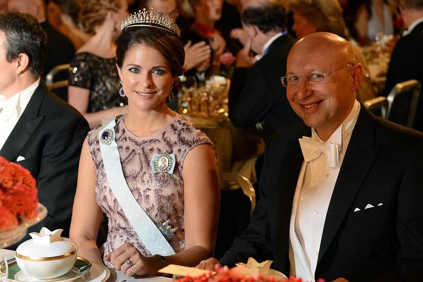 Princess Madeleine of Sweden (left) and the 2014 Nobel Prize in Chemistry laureate Stefan W. Hell attend the Nobel banquet, a traditional dinner after the Nobel Prize award ceremony at the Stockholm City Hall on Dec 10, 2014. -- PHOTO: AFP