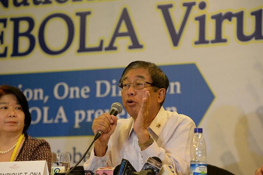 Mr Enrique Ona (right), Philippine Health Secretary gestures as he speaks at a press conference during the national Ebola virus summit in Manila on Oct 10, 2014, while Ms Socorro Lupisan, head of research institute for topical medicine listens. -- PH