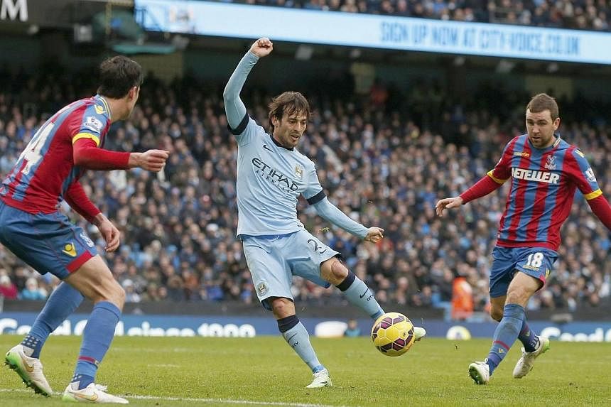 Manchester City's David Silva (centre) shoots to score his second goal against Crystal Palace during their English Premier League soccer match at the Etihad Stadium in Manchester, northern England Dec 20, 2014. -- PHOTO: REUTERS