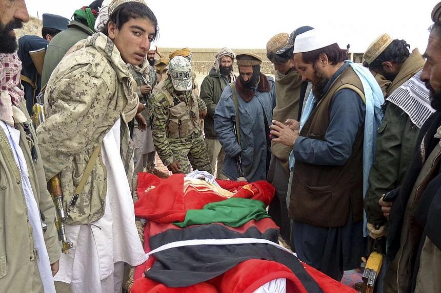 Afghan men gather around the bodies of victims of a suicide attack at a volleyball match in Yahya Khail district, Paktika province, Nov 24, 2014.&nbsp;&nbsp;At least 3,188 Afghan civilians have been killed in the intensifying war with the Taleban in 
